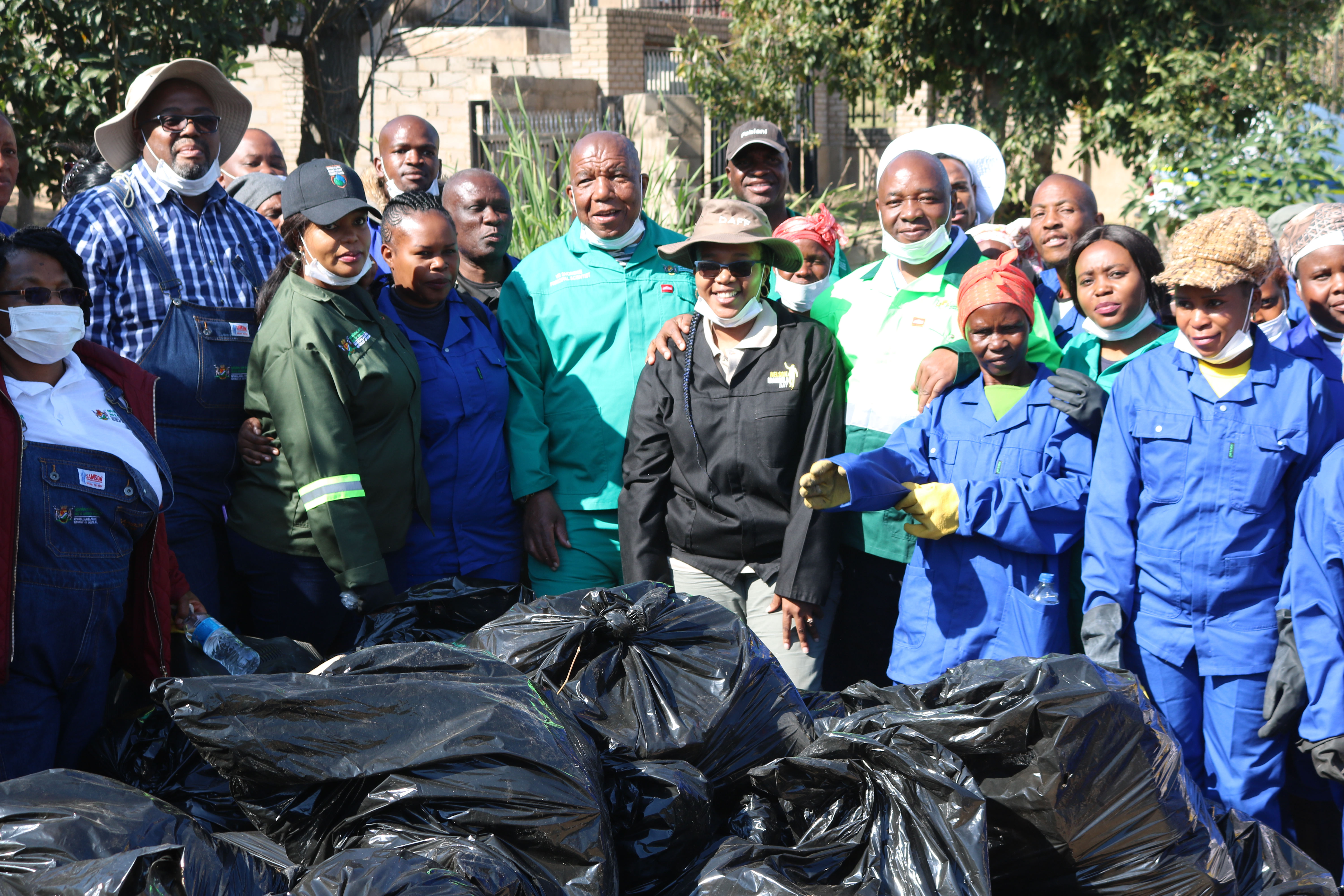 MEC VR Shongwe and HOD Lucky Monareng in a group picture with the collected waste